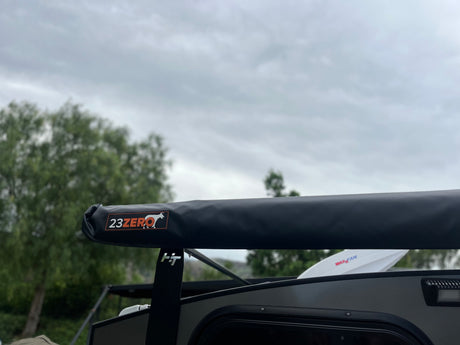 Close-up of a 23ZERO awning on an RV rental, with a visible MaxxFan and cloudy sky. Ready for your next adventure.