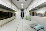 Spacious camper van interior for your next rv rental adventure. Features comfortable bed/seating and overhead storage.
