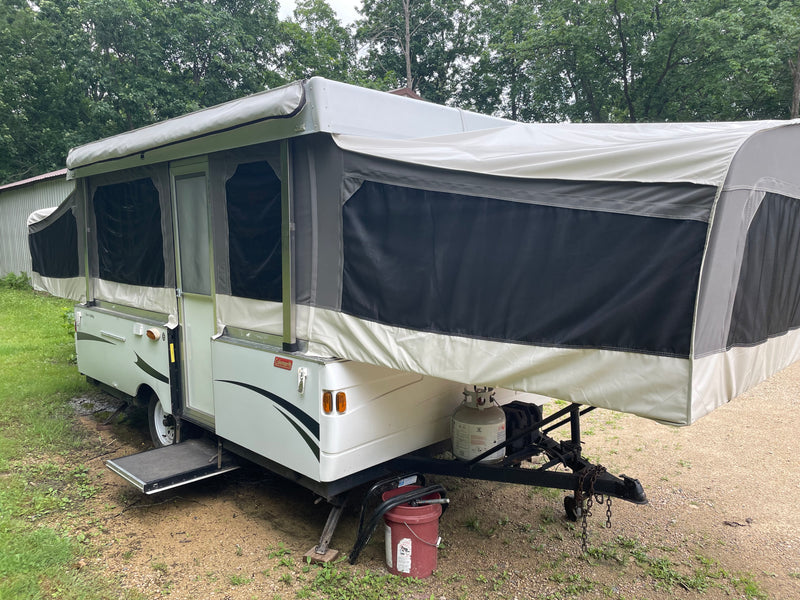 Pop-up RV rental: A fully extended white and grey camper with canvas walls, set up outdoors for camping. — photo 2