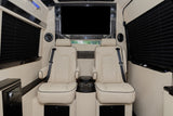 Luxury rv rental: Relax in plush cream captain's chairs with seatbelts, large TV, and privacy blinds in this comfortable interior.