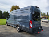 Dark grey Ford Transit 250 high-roof van, suitable for rv rental or custom camper conversion. Features side windows.