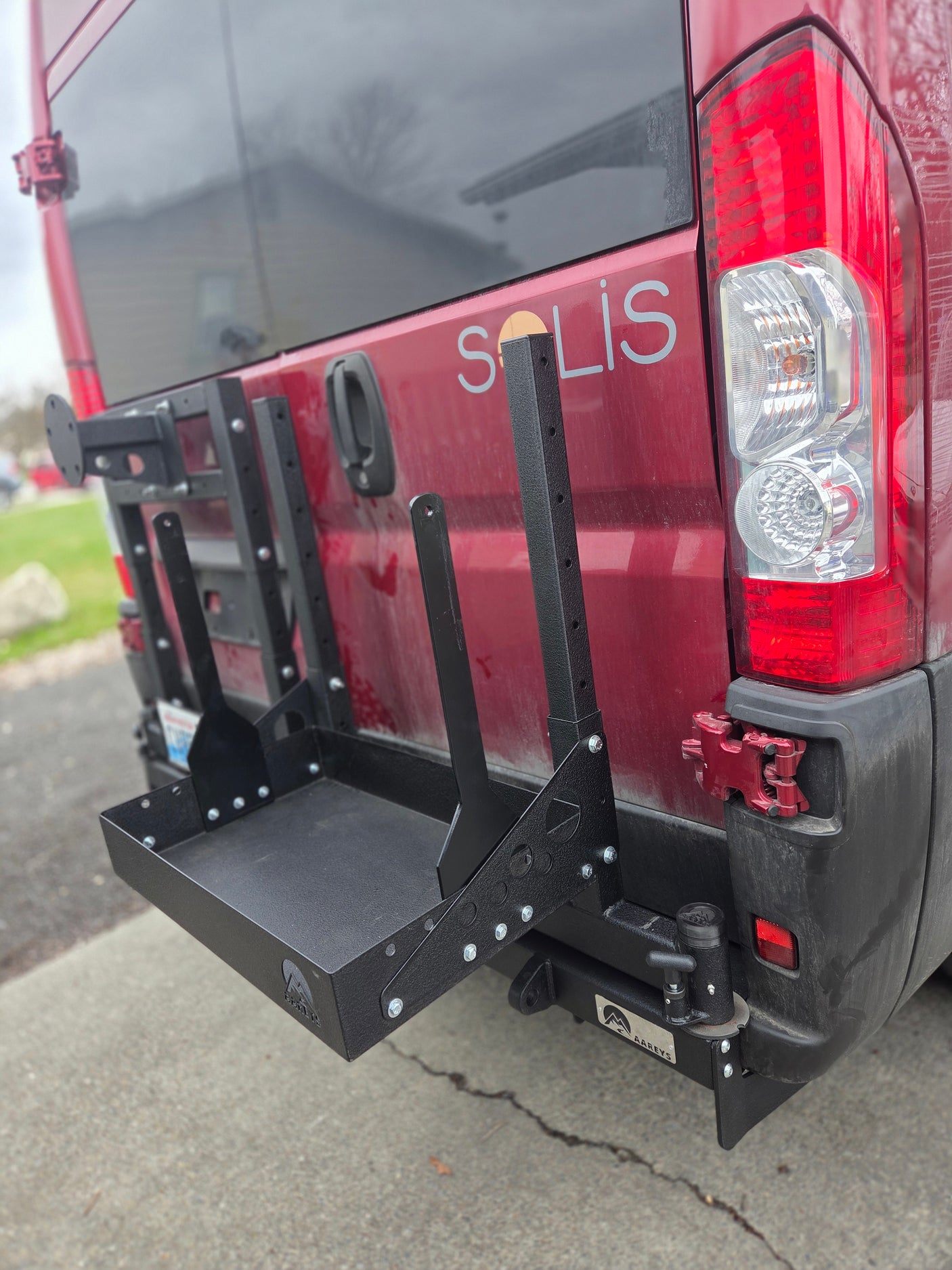 RV rental: Winnebago Solis camper van featuring a rugged rear cargo rack for essential outdoor gear.