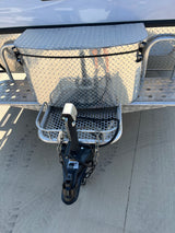 RV rental: Close-up of trailer hitch, safety chains, and diamond plate storage box.