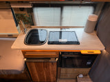 This rv rental galley features a sink, Dometic stovetop, Nova Kool fridge, High Pointe microwave, and paper towel holder.