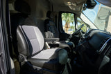 Spacious RV rental interior with driver & passenger seats, dashboard, and a sunny palm tree view.