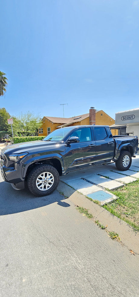 Dark grey Toyota Tacoma pickup with a Scout RV camper. Ready for overlanding or your next rv rental adventure.