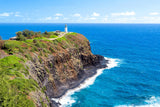 Kilauea Lighthouse atop a lush cliff overlooking Hawaii's blue ocean. Experience island beauty with an RV rental.
