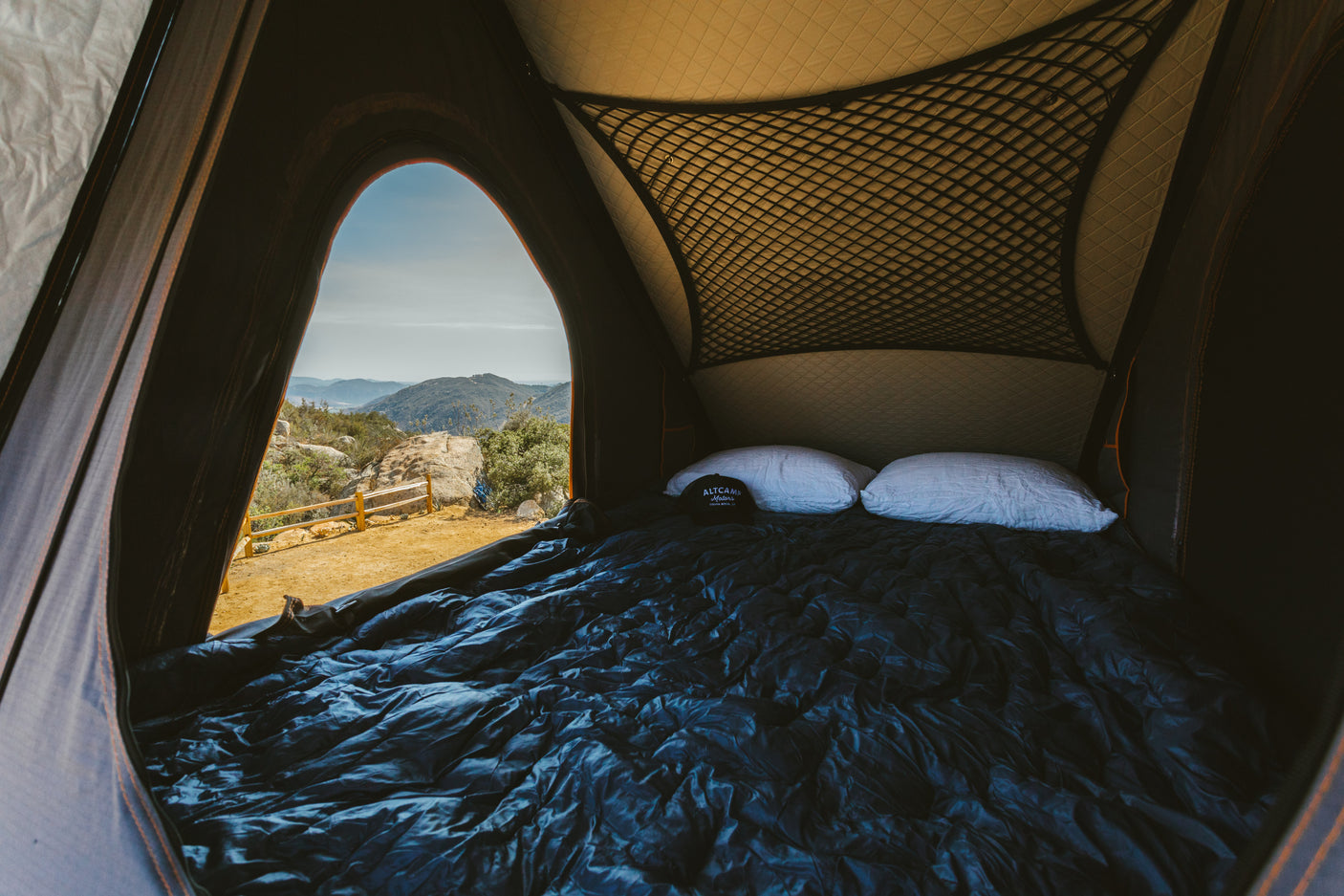 Enjoy mountain views from this cozy RV rental bed, perfect for comfortable outdoor camping adventures.