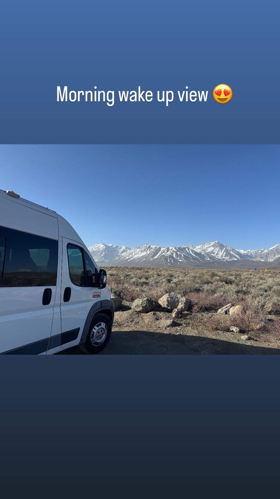 Scenic morning wake-up from an RV rental! White camper van faces majestic snow-capped mountains in desert.