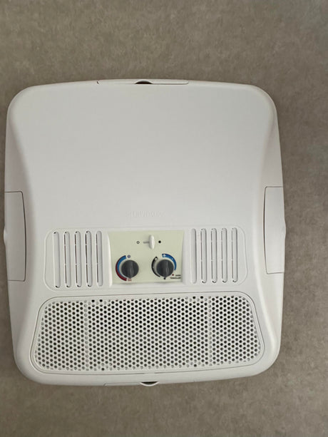 Close-up of a Dometic RV rental air conditioner unit on the ceiling, displaying its fan, temp controls, and vents.