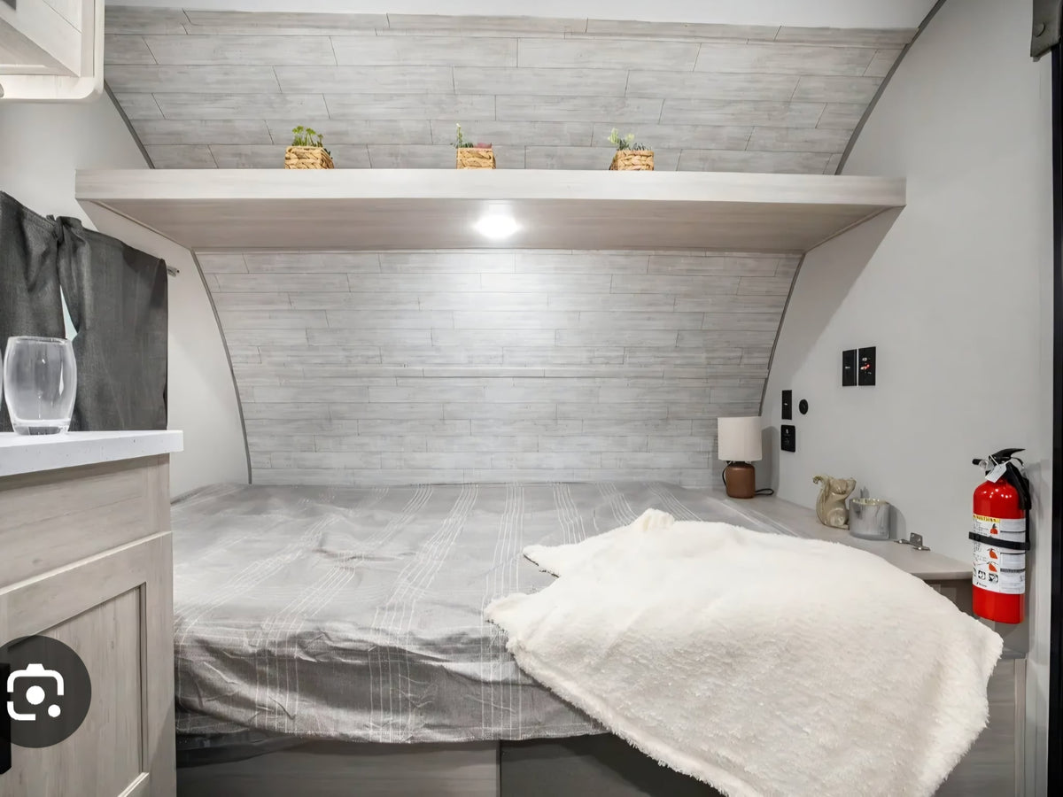  parked on asphalt under a blue sky.|Bright rv rental interior featuring a modern kitchen — photo 4