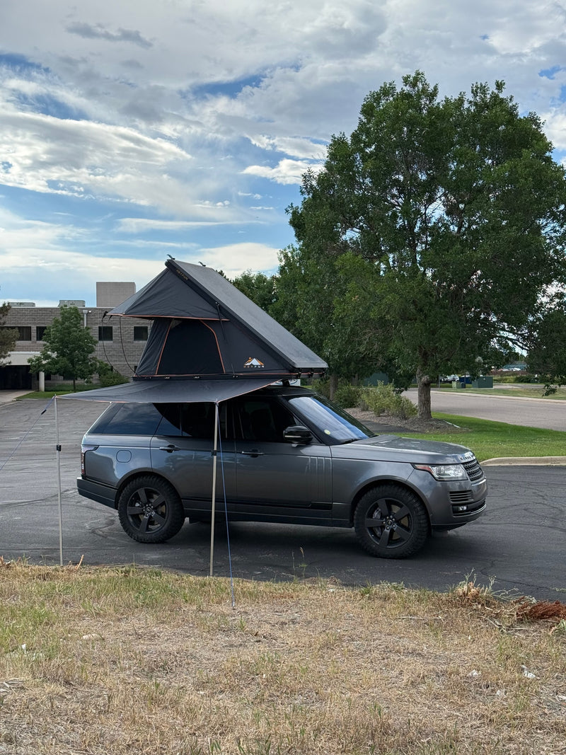 Explore with this gray Range Rover featuring a rooftop tent and awning. A unique RV rental option for your next outdoor adventure. — photo 6