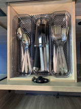 RV rental: Organized kitchen drawer with silver spoons, knives, & forks in clear plastic organizers on a checkered mat.