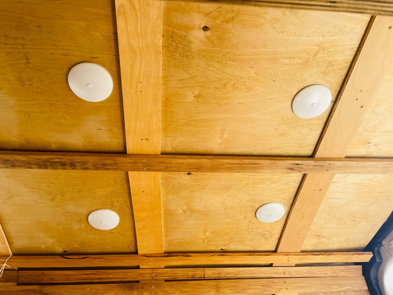 Wooden ceiling with four white lights and wooden beams inside an RV rental. Ideal for camper van adventures. — photo 16