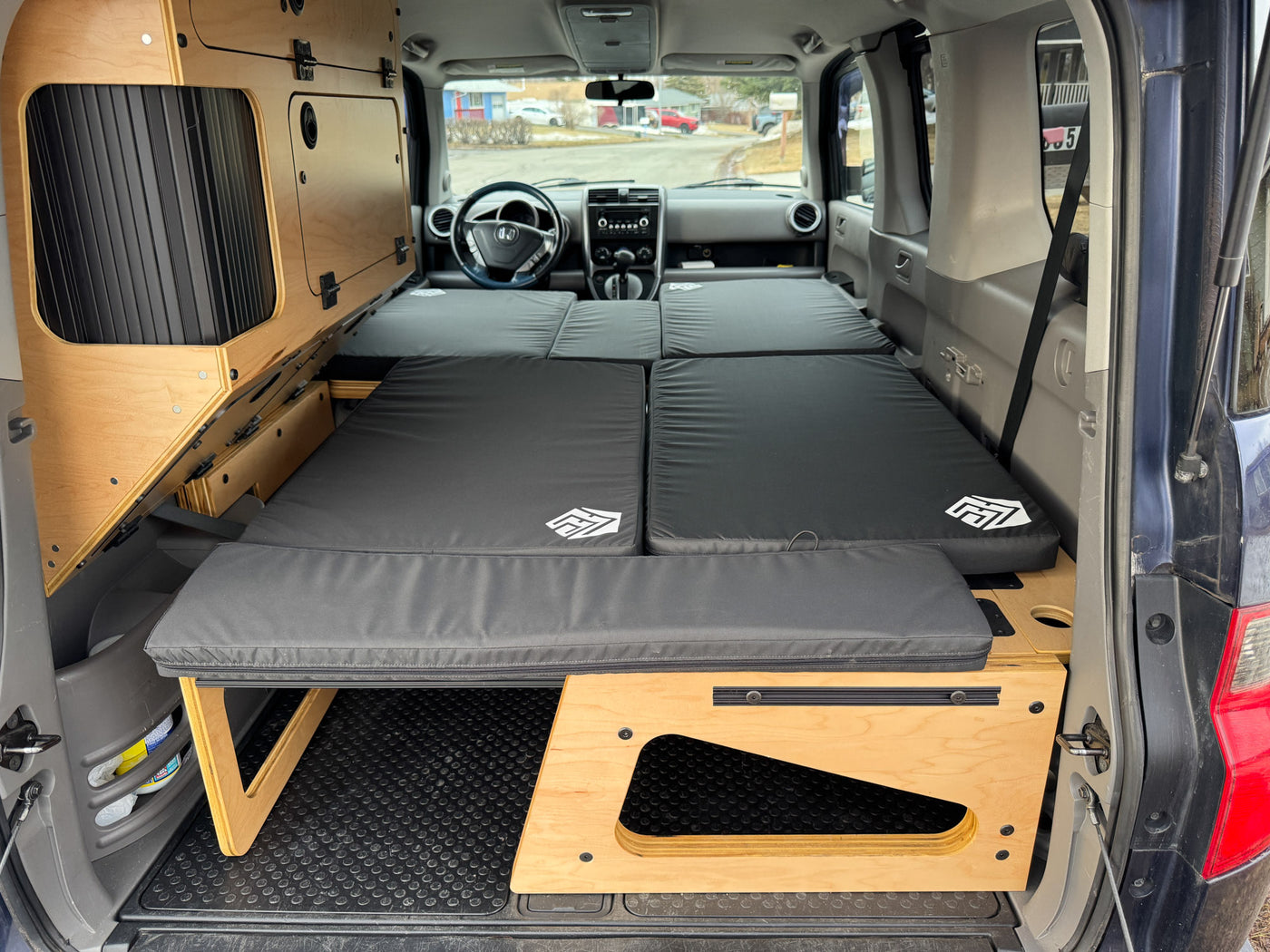 wooden supports.|RV rental: Interior of a camper van with a black modular bed — photo 6