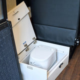 RV rental: A Dometic portable toilet is neatly stored in a pull-out compartment under a seat for compact convenience.