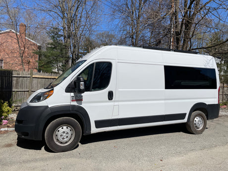 Explore in this white Ram ProMaster campervan, available for RV rental.