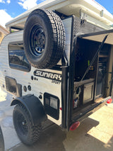White Sunray Sport teardrop camper RV rental with an open outdoor kitchen at the rear and a rooftop tent.