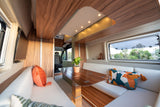 Experience comfort in this rv rental's modern interior, featuring a bright dining area, plush seating, and scenic window views.