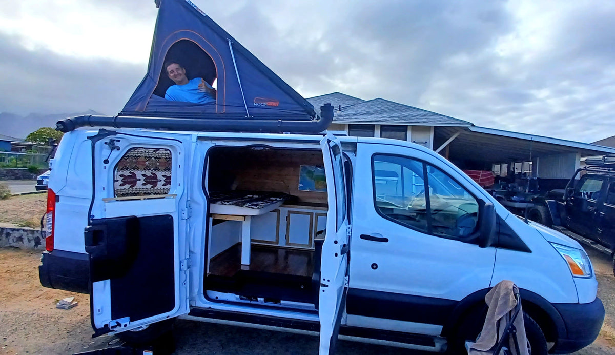  dances on an RV rental dashboard. A fun travel companion.|Baby watches vibrant sunset over the ocean from our cozy rv rental tent. Perfect family travel & camping.|This white camper van — photo 9
