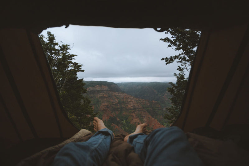 Feet up, tent view of a majestic canyon. Your RV rental journey leads to stunning nature escapes & camping. — photo 8