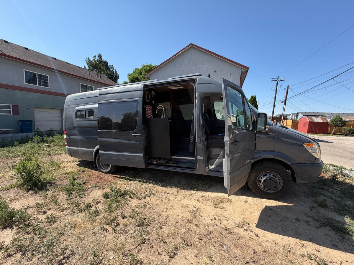 Dark gray RV rental Sprinter van with doors open — photo 1