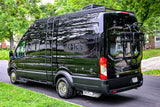 Black Ford Transit RV rental: a fully equipped camper van with roof rack, ladder, bike rack, and dually wheels, ready for adventure.