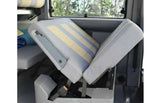 RV rental camper van's convertible bed/seat. Striped cushions are partially folded, revealing adaptable interior space.