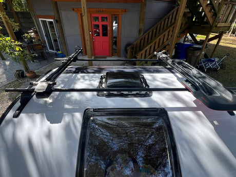 White RV roof with two skylights and a black Yakima roof rack. Great for your next rv rental adventure!