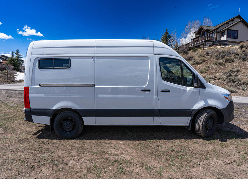  illuminated by a brilliant sun flare.|Sunset van life: An RV rental parked in desert at dusk — photo 9