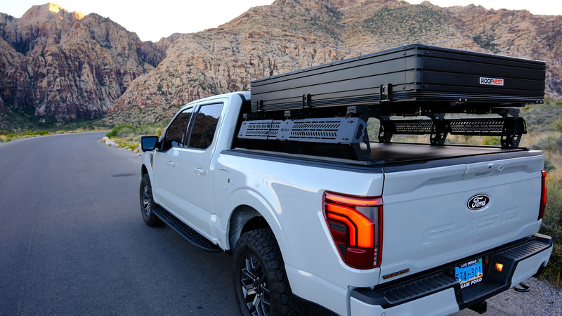 White Ford F-150 pickup with a Roofnest rooftop tent and bed rack, ideal for an RV rental and overlanding adventure in the mountains. — photo 19
