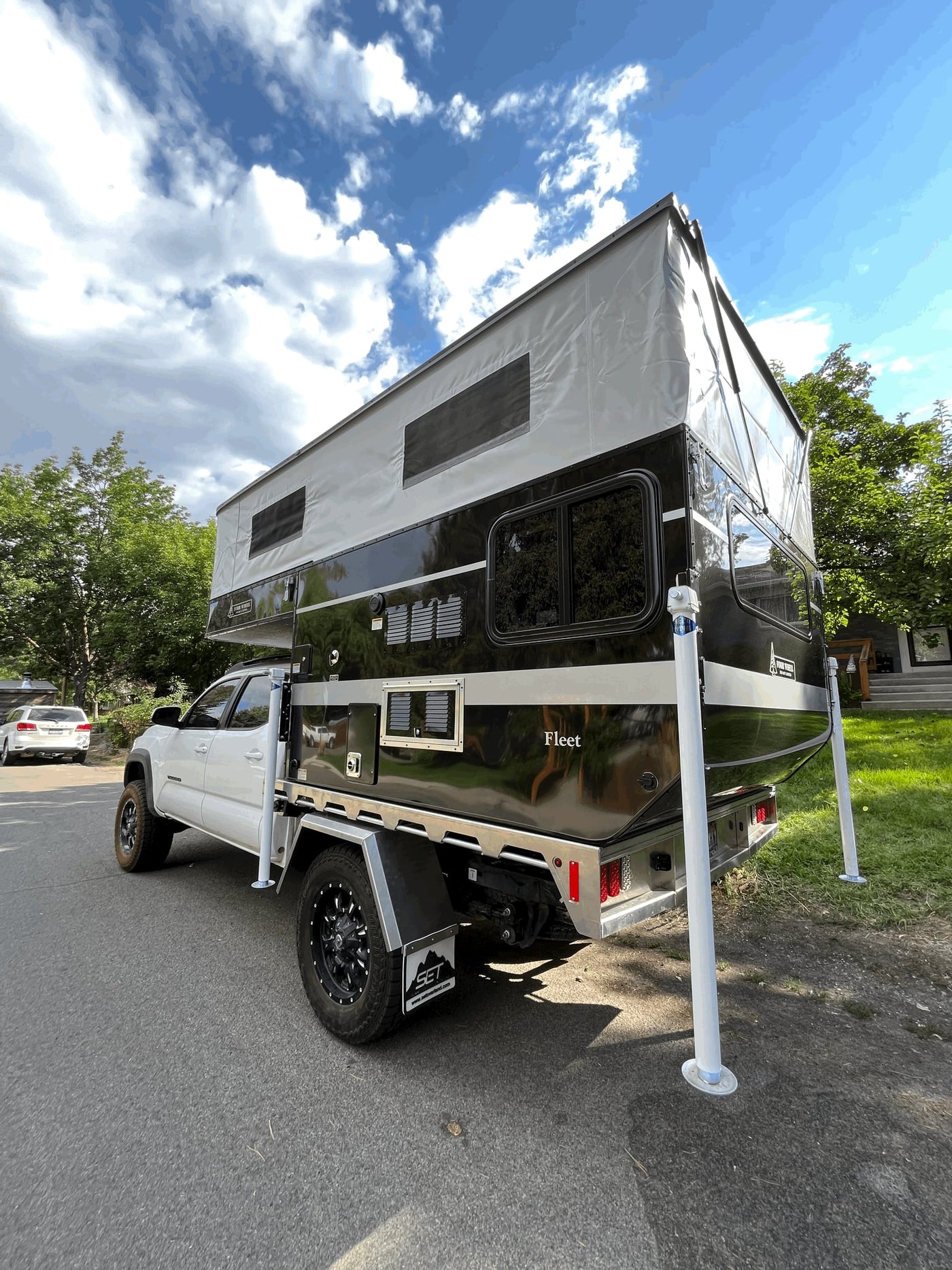  equipped with a black Four Wheel Fleet pop-up truck camper — photo 4