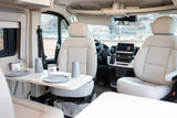 Spacious RV rental interior with swivel seats and a dining table set for meals, ideal for comfortable travel.