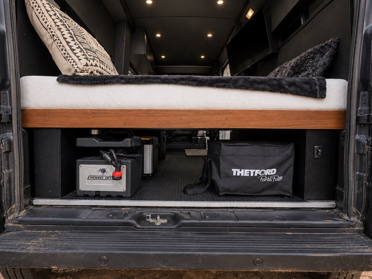  with Montana mountains & pines at dusk. Ready for adventure.|Front view of a black RV rental camper van parked on gravel — photo 12