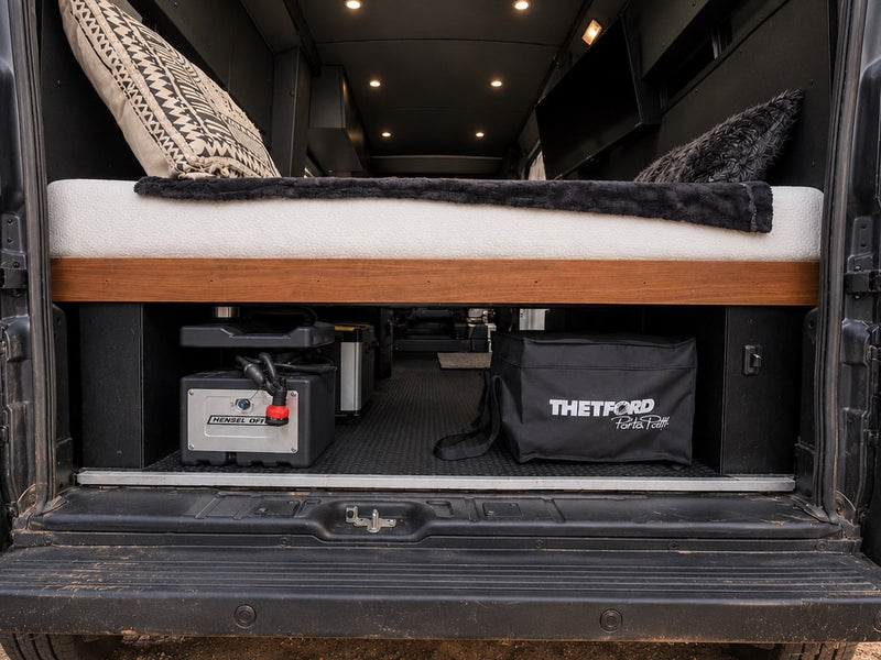  with Montana mountains & pines at dusk. Ready for adventure.|Front view of a black RV rental camper van parked on gravel — photo 12
