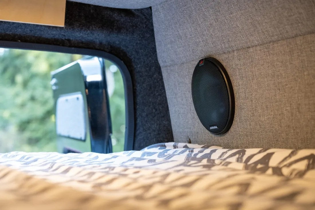  and two rear passenger seats for travel.|Explore in comfort: RV rental camper van interior with kitchen — photo 7
