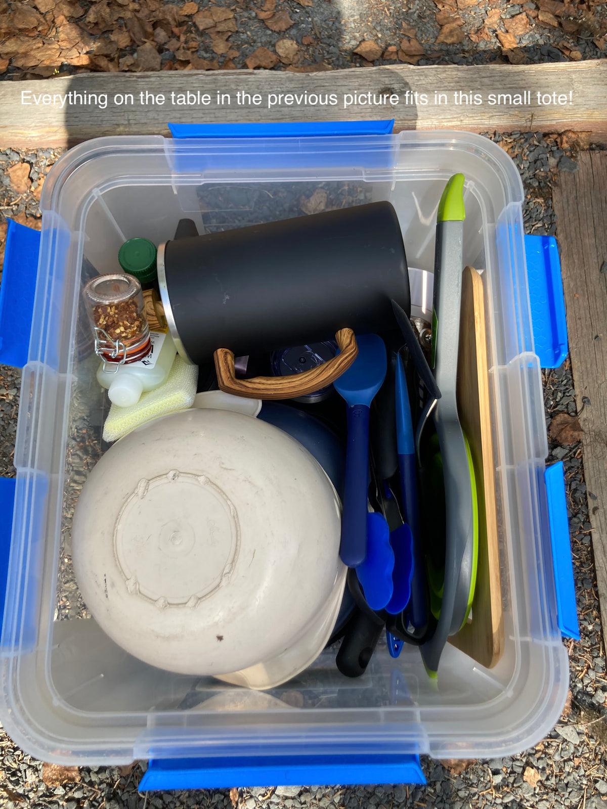 Organized RV rental kitchen gear: cooking utensils, bowls, spices, and cleaning supplies neatly packed in a clear tote. — photo 14