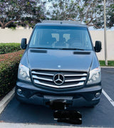 Front view of a dark gray Mercedes-Benz Sprinter van, ready for your next RV rental adventure.