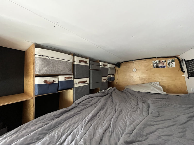  and a versatile fold-down table over seating.|RV rental: View inside a modern camper van with a kitchen — photo 8