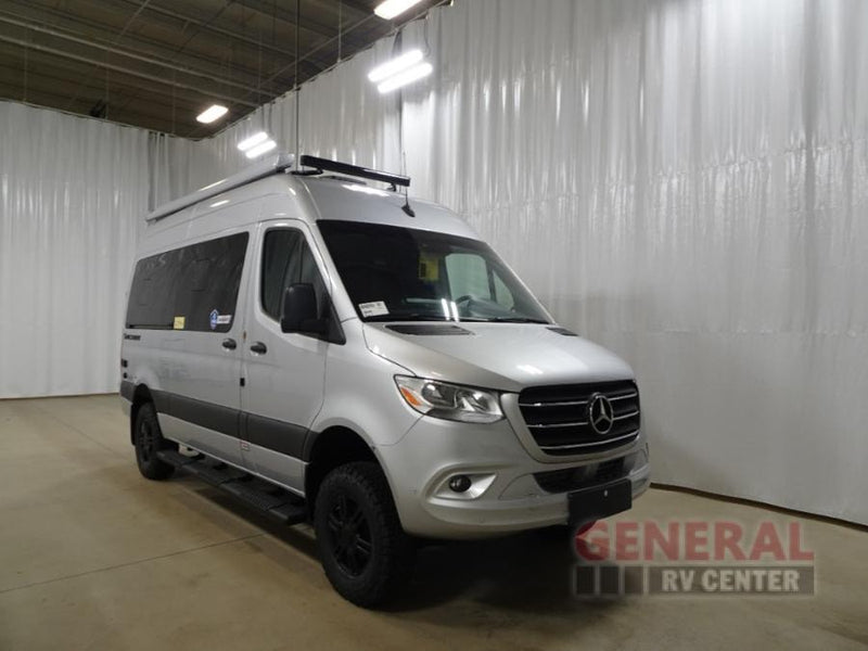 Silver Mercedes-Benz Sprinter camper van, ideal for your next adventure rv rental. Features roof rack and off-road tires. — photo 1