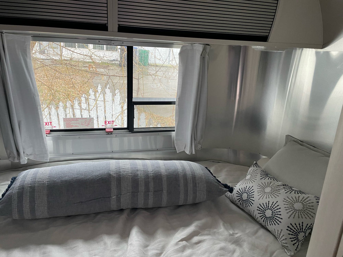  glistens with snowflakes while parked outdoors.|Cozy RV rental interior with a compact kitchen (sink — photo 3