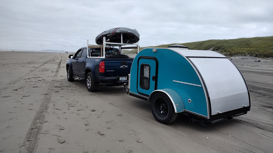  and cooler.|Explore with this vibrant teal & silver teardrop camper