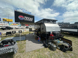 Experience race day camping! This equipped off-road RV setup at Texas Motor Speedway is perfect for an RV rental adventure.