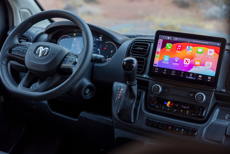 Modern rv rental interior: view of the dashboard with a large infotainment screen, steering wheel, and gear shifter. — photo 17