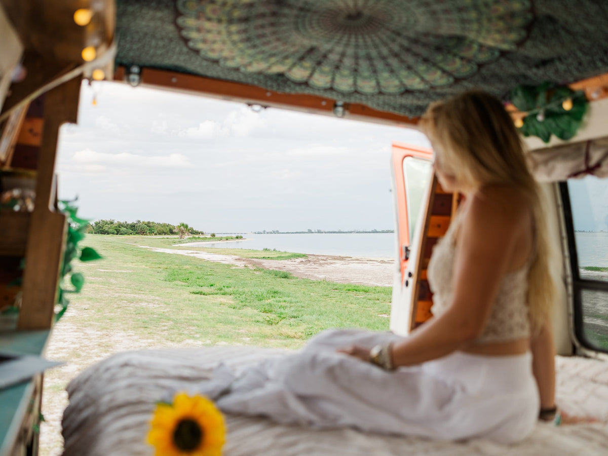  perfect for road trip travel.|Woman enjoying the peaceful outdoor view from her cozy **RV rental** **camper van**. Perfect for embracing **van life** and **travel**.|Smiling woman happily working on her laptop inside a cozy RV rental — photo 8