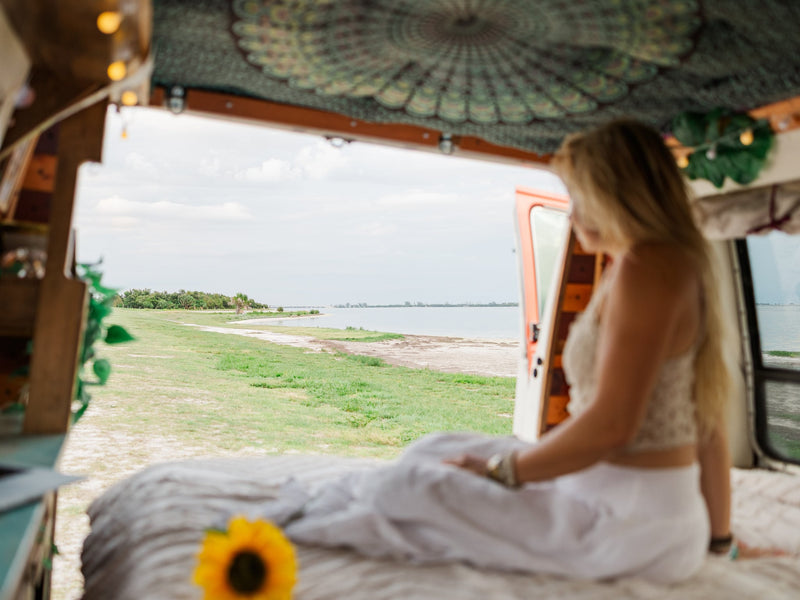  perfect for road trip travel.|Woman enjoying the peaceful outdoor view from her cozy **RV rental** **camper van**. Perfect for embracing **van life** and **travel**.|Smiling woman happily working on her laptop inside a cozy RV rental — photo 8