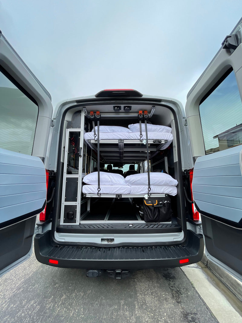 Rear view of a grey van converted for RV rental, featuring a custom interior with two stacked bunks & storage solutions. — photo 3