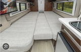 Inside an **rv rental**: dual beds convert to full sleeping area, with TV and small kitchen. Ideal for road trips.