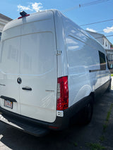 White Mercedes-Benz Sprinter van, rear/side view. Ideal for RV rental adventures or custom builds.