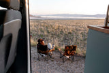 Enjoying the view from an RV rental. Relaxing by a vast lake & mountains at sunset. Perfect for nature lovers!